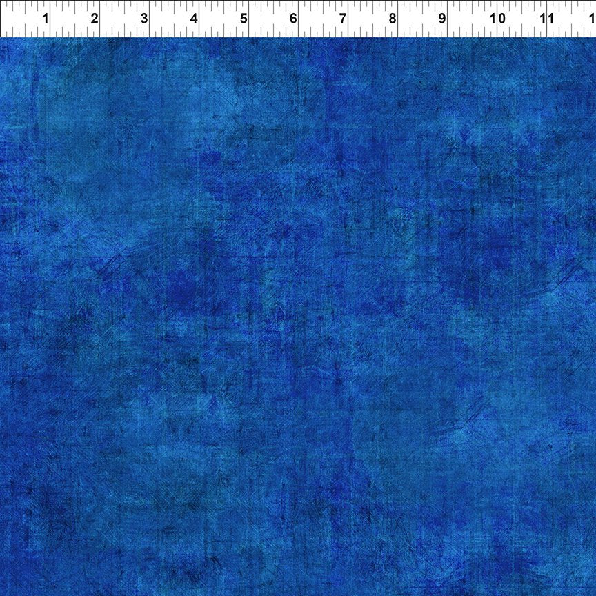 A yard of blue cotton fabric with a textured design, indicating it is part of a fabric collection designed by Jason Yenter.