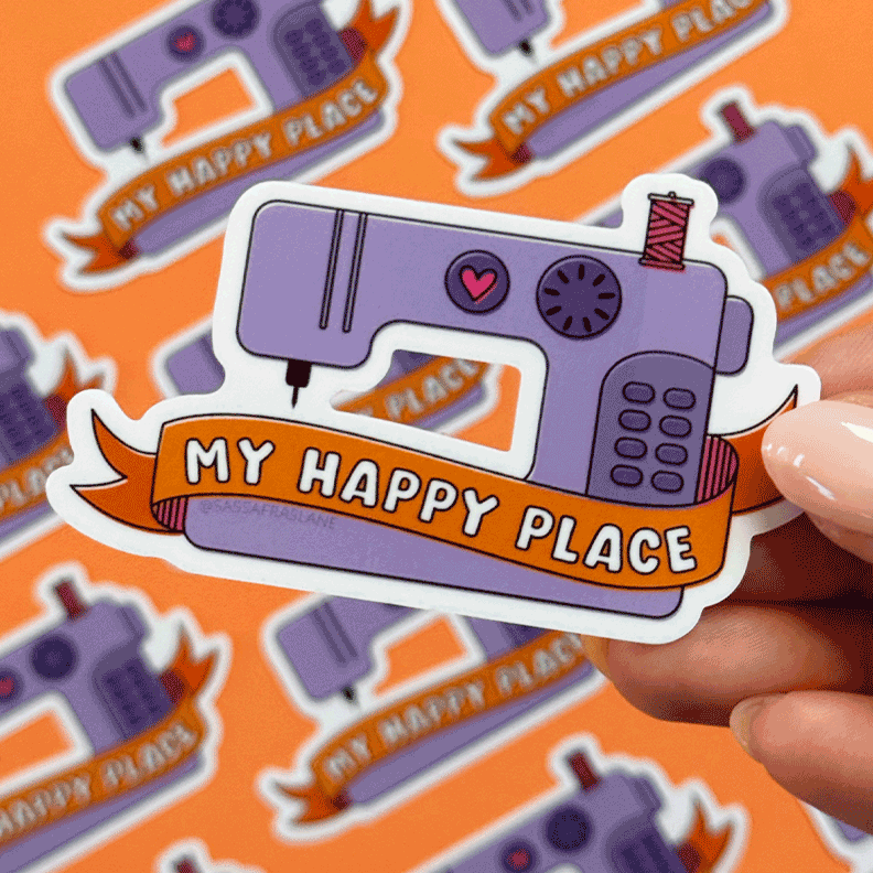 Sticker of a sewing machine with 'My Happy Place' text on an orange background