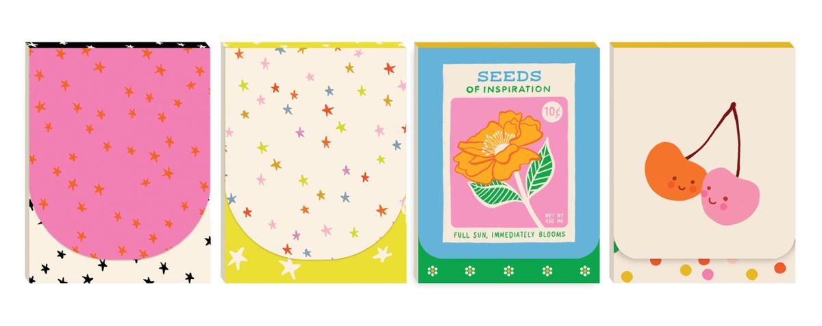 Set of four colorful notebooks with different designs on a white background