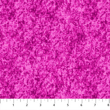 A yardstick showing scale of a pink acid wash fabric pattern.