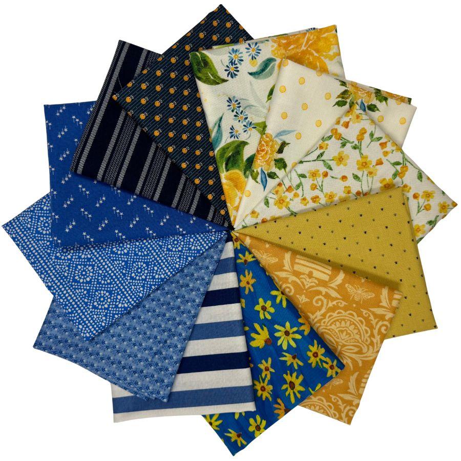 A fan arrangement of multiple fabric swatches showing various patterns and colors, including blue floral, yellow floral, navy stripes, white stripes, and polka dots, on a solid white background.